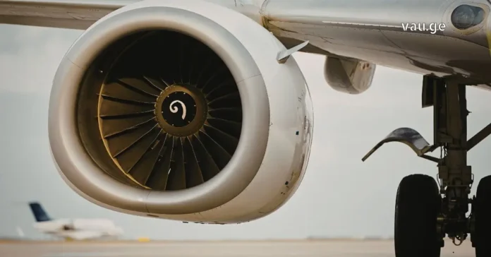 Modern commercial airplane flying above clouds representing aviation technology.