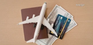 როგორ დავგეგმოთ ოცნების შვებულება: გზამკვლევი თანამედროვე მოგზაურებისთვის Travel planning essentials with laptop, airplane tickets, and world map on a wooden table