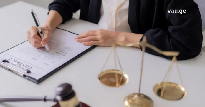 A professional setting showing legal documents, a pen, and the scales of justice representing commercial law and business contracts.