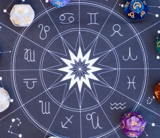 სად გელით ბედნიერება ზოდიაქოს ნიშნის მიხედვით? Top view of a dark blue astrological zodiac wheel chart with colorful dice featuring celestial symbols.