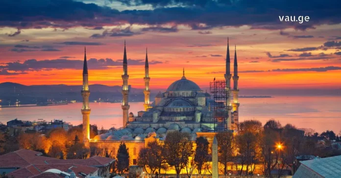 Panoramic view of Istanbul with Bosphorus bridge and mosques at sunset.