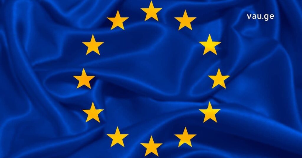 Waving European Union flag with blue fabric and yellow stars, representing Georgia's visa-free travel and European integration.