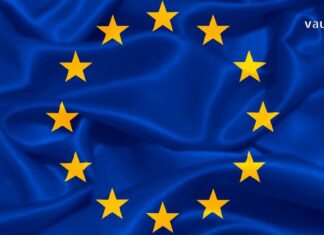 ევროპული თავისუფლების გზა: 2017 წლამდელი ბარიერები და 2026 წლის გაურკვევლობა Waving European Union flag with blue fabric and yellow stars, representing Georgia's visa-free travel and European integration.